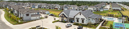 A suburban neighborhood with houses and a road.