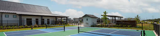 A tennis court with a blue and green surface and white lines.