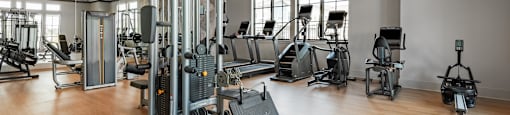 A gym with a variety of equipment including a leg press machine.