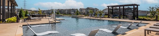 A large outdoor pool with a waterfall feature.