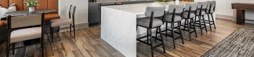 A modern kitchen with a bar area and seating.