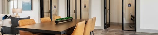 A modern dining room with a wooden table and chairs.