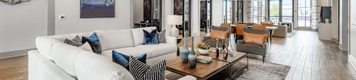 A modern living room with a white sofa and a wooden coffee table.
