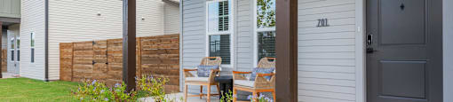 A house numbered 201 has a grey door and a porch.