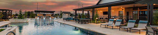 A poolside area with a sun lounger and a table.