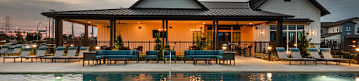 A house with a pool in front of it.