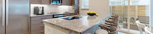 a kitchen with stainless steel appliances and a granite counter top