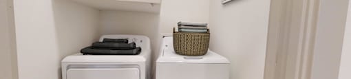 a small laundry room with two washes and a dryer