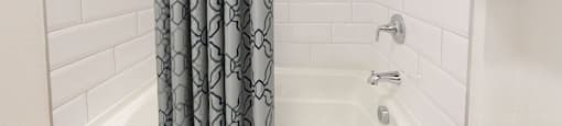 a bathroom with a shower and a shower curtain