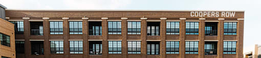 A large brick building with the words "Coopers Row" on the top.