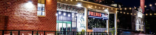 the building in which the hotel is located is lit up at night