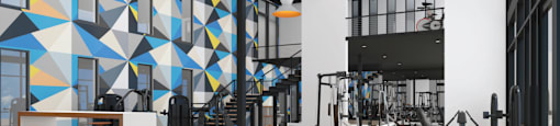 A gym with a variety of equipment and a geometric wall design.