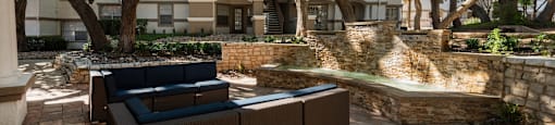 a courtyard with furniture and a fountain in front of an apartment building  at Hayden on West Ave, San Antonio