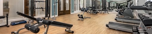 2200 sq ft gym with cardio equipment and weights on a wood floor  at Hayden on West Ave, San Antonio