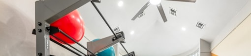 a workout room with weights and a gym ball on the floor and a large window  at Hayden on West Ave, San Antonio