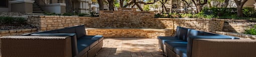 a patio with furniture in front of an apartment building  at Hayden on West Ave, San Antonio, TX, 78216