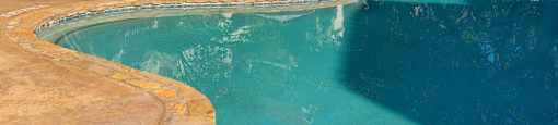 a swimming pool with chairs and umbrellas near a hotel  at Hayden on West Ave, San Antonio, Texas
