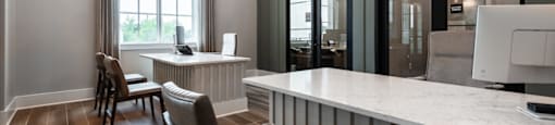 A modern kitchen with a bar area and a dining table.