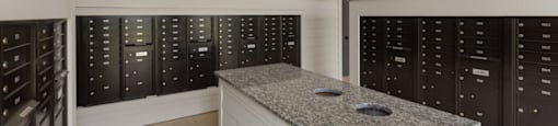 A kitchen with a granite countertop and black cabinets.