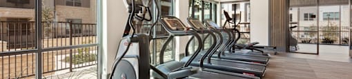 gym with amenities at ironridge at hill country village apartments