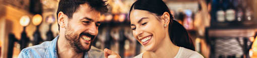 A man and a woman are enjoying a meal together in a restaurant.