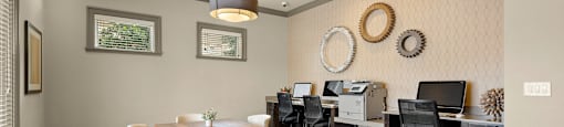 a dining room with a table and chairs and a computer desk