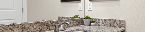 a kitchen counter with a sink and wooden cabinets