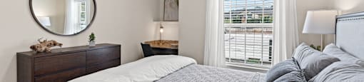 a bedroom with a large bed and a ceiling fan