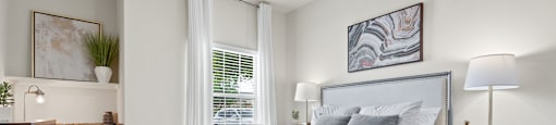 a bedroom with a large bed and a ceiling fan