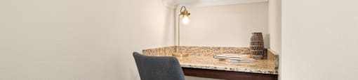 a desk with a chair in a corner of a room