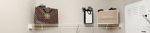spacious laundry room with hooks and shelves and a washer and dryer