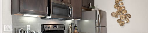 a kitchen with stainless steel appliances and wooden cabinets