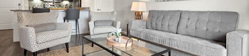 a living room with a couch and two chairs