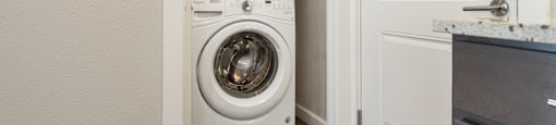 a front loading washer and dryer in a laundry room