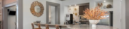 a kitchen with a marble counter top and bar stools
