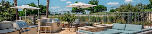 outdoor grilling area at the green at plum creek apartments