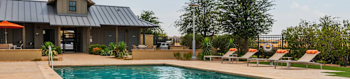 a pool with a house in the background