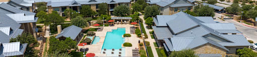 an aerial view of a house with a swimming pool in the backyard
