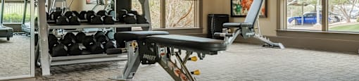 a home gym with a treadmill and weights