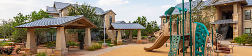 a playground at the whispering winds apartments in pearland, tx