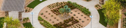 an aerial view of a garden in a parking lot