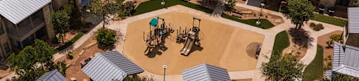 an aerial view of a playground in the courtyard of an apartment complex