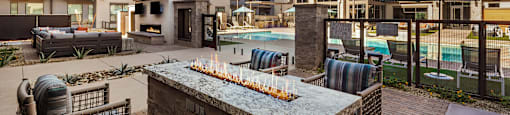 A patio area with a fireplace and seating area.