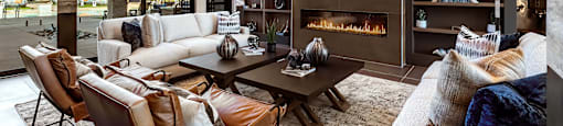A modern living room with a fireplace and a view of the city.