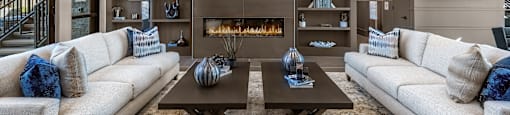 A modern living room with a fireplace and a flat screen TV.