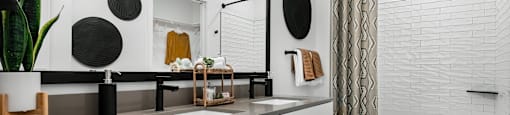 A white bathroom with a wooden floor and a white tub.