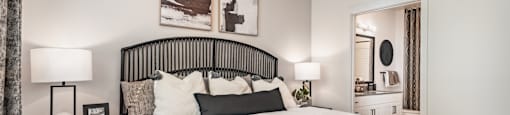 A bedroom with a large bed and a ceiling fan.