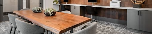 a dining room with a wooden table and chairs