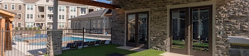 a backyard with grass and yoga mats and a pool