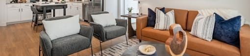 a living room with a couch and chairs and a table